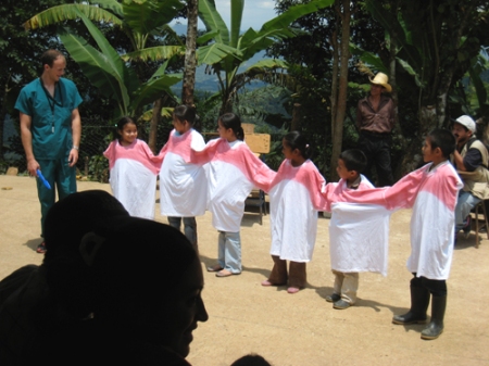 Sam Olson shows Guatemalans about brushing teeth.